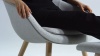 A front angle view of the About A Lounge Chair with a low back and wood base.