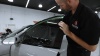 a tech preparing a sports car for ceramic window tint installation