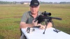 The author demonstrating how to sight in a rifle at a shooting range in a video