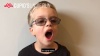 Child wearing glasses and yawning