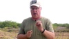 The author demonstrates how to hold a gun in a video.